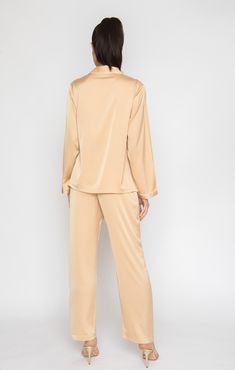 Treat yourself to lavishness with the Champagne Long PJ Set. Sumptuous polysilk fabric and a swingy design will make you feel like you're gliding on a cloud. Timeless hue. Coziness and everlasting flair come together in this remarkable set to assist you in recharging and connecting to your perfect tranquil moment! Long-sleeve button-up and drawstring waist long pants Detailed white trim, classic collar and button down top Drawstrings w/elastic waist for perfect fit Made of breathable poly-silk b Chic Silk Loungewear Sets, Elegant Satin Daywear Set, Spring Satin Sets For Daywear, Luxury Silk Long Sleeve Sets, Luxury Long Sleeve Silk Set, Silk Sets For Daywear, Chic Silk Long Sleeve Sets, Chic Long Sleeve Silk Sets, Silk Long Sleeve Evening Sets