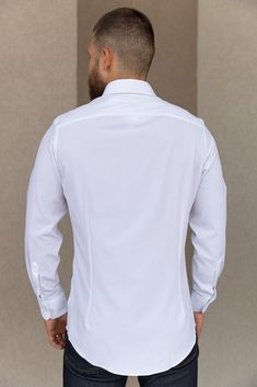 Product Description Long sleeve, button-down, white trim fit shirt. This best selling Leeward style features performance fabric that will make this a go to in your wardrobe. Details & Fit Recommend ordering true to size Front Body Length: 29.5" (Measured from Large) Performance fabric dress shirt Superior quick-dry properties Wrinkle resistant Spread collar Back darts Long sleeves Convertible cuffs Curved hem Materials & Care 85% Polyester 15% Spandex Machine Wash Cold Modern White Shirt With Lapel Collar, White Shirt With Button Cuffs And Lapel Collar, White Semi-formal Shirt With Button Cuffs, Fitted White Top With Button Cuffs, Modern White Dress Shirt With Button Closure, White Business Dress Shirt With Buttons, White Dress Shirt With Buttons For Business, White Collared Dress Shirt With Button Cuffs, White Dress Shirt For Business