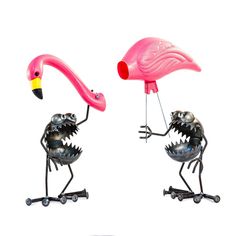 two metal flamingos standing next to each other