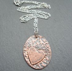 Copper oval pendant with a heart of copper which has been solder onto the oval base. the pendant has been ,sanded, Stamped to give texture, oxidised to give an aged look. the copper then has had a coat of lacquer to help protect the petina Pendant has been attached to a sterling silver chain Copper pendant measures approx 32 mm by 24 mm Add to basket Chain available in a 16" 18" and 20" chain select from the options Pendant will come in a gift box Jewelry Making Workshop, Copper Jewellery, Diamond Heart Pendant Necklace, Jewelry Design Inspiration, Heart Shaped Jewelry, Silver Jewelry Design, Sterling Silver Chain Necklace, Heart Pendant Diamond