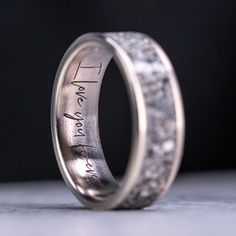 a wedding ring with the word love written on it