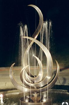 a fountain with water spouting from it's sides