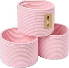 three pink braided storage baskets are stacked on top of each other, with a price tag