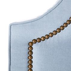 the beaded necklace is attached to a light blue shirt with brown beads on it