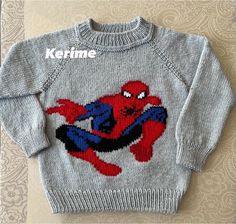 a knitted sweater with a spiderman on it