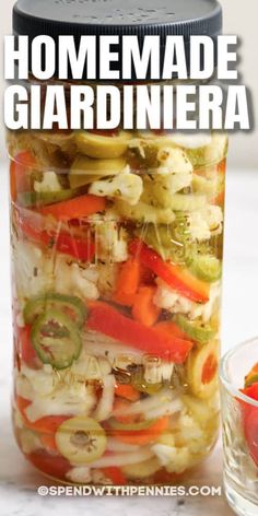 a jar filled with pickles, peppers and onions