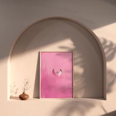 a pink painting hangs on the wall next to a potted plant and an arch