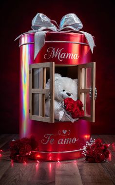 a teddy bear in a red box with the word mama written on it and roses