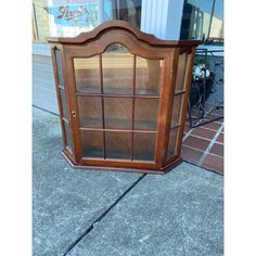 a wooden display case sitting on top of a sidewalk