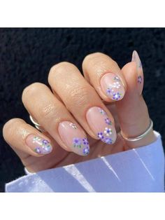 a woman's hand with pink and purple nail polish