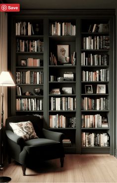 a chair in front of a bookshelf with lots of books on the shelves