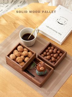 a wooden tray with nuts and coffee on it next to a book that says solid wood pallet