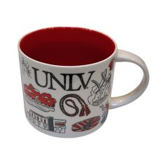 a red and white coffee mug with the words univ on it's side