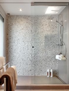 a bathroom with a walk in shower next to a window