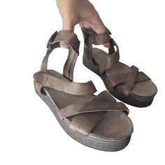 These Aetrex Women's Strappy Sandals Are Stylish And Versatile, Featuring A Durable Synthetic Upper And A Comfortable Rubber Sole. With Their Neutral Colors, They Can Easily Be Paired With Various Outfits For Casual Or Semi-Formal Occasions. The Adjustable Buckle Ensures A Secure Fit, Making Them Both Fashionable And Functional. Adjustable Buckle Closure Durable Synthetic Upper Comfortable Rubber Sole Neutral Colors Versatile Design Minor Scuffs On Straps And Footbed. Sole In Excellent Condition Adjustable Brown T-strap Sandals, Aetrex Shoes, Brown Ankle Strap Synthetic T-strap Sandals, Brown T-strap Sandals With Adjustable Strap For Beach, Brown Adjustable T-strap Sandals With Cushioned Footbed, Womens Strappy Sandals, Brown Synthetic T-strap Sandals With Removable Insole, Strappy Leather Sandals, Womens Shoes Wedges