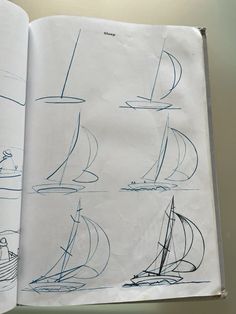 an open book with drawings of sailboats on it