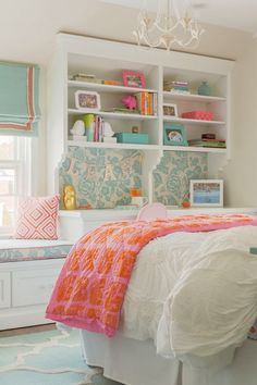 a bedroom with white furniture and colorful accessories