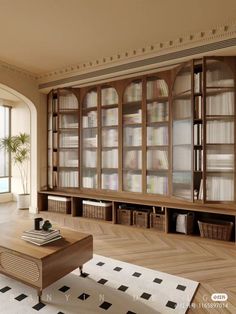 a living room filled with lots of bookshelves next to a table and chairs