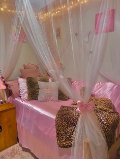 a bedroom with pink and leopard print bedding