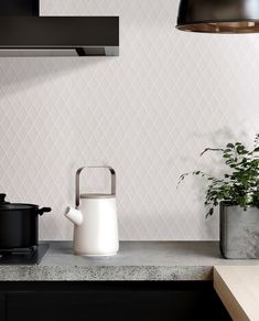 a kitchen counter with a kettle and pot on it