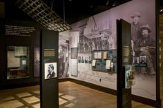 an exhibit room with posters and pictures on the wall