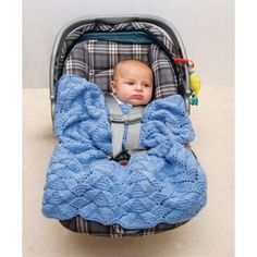 a baby in a car seat with a blue blanket on it's back and head