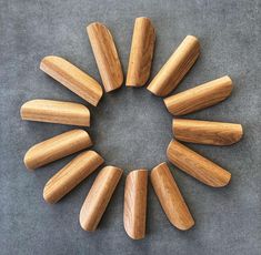 a circular arrangement of wooden pieces arranged in the shape of a circle on a gray surface