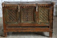 an old wooden cabinet with carvings on it