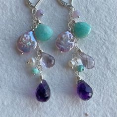 *please note if you are purchasing on facebook or instagram shops you will receive this item in sterling silver with a hook earwire, not the leverbacks shown, with no metal options. I designed this cascade of color for my February birthstone/birthday people. Happy Birthday! I've used scorolite opal, purple freshwater pearls, amazonite, amethyst in purple and pink (it's a lavender) and freshwater pearls. Please choose your earwire and metal choice. These are wired sterling silver on sterling silv Sterling Silver Gemstone Cluster Earrings As Gift, Silver Gemstone Cluster Earrings In Sterling Silver, Handmade Sterling Silver Round Chandelier Earrings, Unique Drop Earrings With Lever Back Ear Wires, Sterling Silver Fusion Chandelier Dangle Earrings, Unique Nickel-free Sterling Silver Chandelier Earrings, Unique Drop Earrings With Lever Back, Fusion Style Sterling Silver Dangle Chandelier Earrings, Nickel-free Sterling Silver Jewelry For Birthday