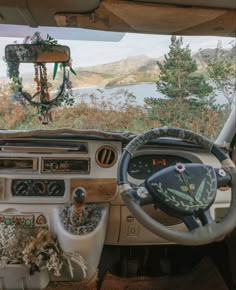 the interior of an old car is decorated with flowers and greenery as well as steering wheel controls