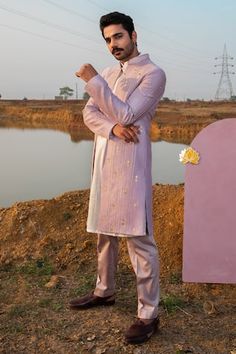 Dusty lilac full sleeve sherwani with pearl, cutdana embellishment in gold motifs. Paired with pearl white kurta and pant pyjama.
Components: 3
Pattern: Embellished
Type Of Work: Cutdana, pearl
Neckline: Mandarin collar
Sleeve Type: Full sleeves
Fabric: Sherwani: Chanderi Silk, Kurta: Pure Cotton, Pant Pyjama: Vegan Silk
Color: Purple
Other Details: 
Disclaimer: The fabrics used, are handwoven, hence may have impurities or slubs/variation in the weave that beautifies the look and should not be c Purple Sherwani, Kurta Set Men, Mehndi Outfit, Dusty Lilac, Kurta Set For Men, Kurta Men, White Kurta, Silk Kurta, Kurta With Pants