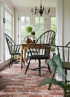 an instagramted photo of a dining room table with chairs and potted plants