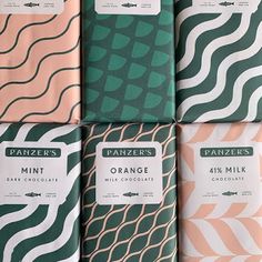 six bars of orange milk chocolate in different patterns and colors, with labels on them