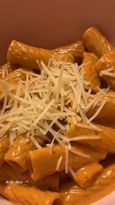 a bowl filled with pasta covered in sauce and cheese