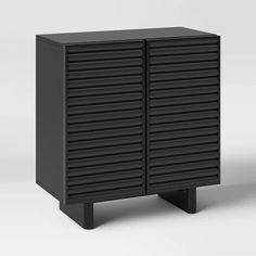 a black cabinet with shutters on the front and bottom, sitting against a white background