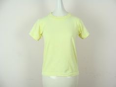 "Bright and fun vintage kid's neon yellow t-shirt from the late 80s / early 90s. Classic tee style with single stitching. Seems to have been dyed yellow, as it's a bit brighter in some places than others and has some fading and dye inconsistencies, which I feel only adds to the coolness and uniqueness of a vintage piece such as this. Label: \"Screen Stars Best\". Made in U.S.A. Fiber content: 50% cotton, 50% polyester. Stamped size: 14-16. Please see measurements to ensure a proper fit. Though i Denim Jumper Dress, Vintage Jumpsuit, Late 80s, Yellow T Shirt, Early 90s, Yellow Top, Overall Dress, Neon Yellow, Kids Tops