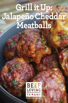 a bowl filled with meatballs sitting on top of a table