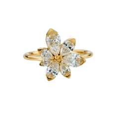 a yellow gold ring with white diamonds on the top and center flower in the middle