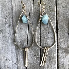 Beautiful Aquamarine stones adorn these timeless earrings. The teardrop hoop and tassel pieces are hand forged and hammered to give texture and sparkle! Product details: Length: Approximately 3" About Aquamarine: Aquamarine is a stone of empowerment, aiding in the realization that not all power comes from force. Aquamarine evokes the purity of crystalline waters, as well as the exhilaration and relaxation of the sea. The stone is calming, soothing, and cleansing, and inspires truth, trust, and l Bohemian Teardrop Hammered Jewelry, Bohemian Hammered Teardrop Jewelry, Hand-forged Teardrop Hoop Earrings, Timeless Earrings, Jewelry Studio, Aquamarine Stone, Blue Jewelry, Gold Filled Jewelry, Hand Forged