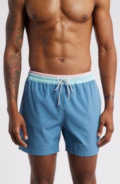 These classic swim trunks are made with quick-drying four-way-stretch fabric and built-in mesh compression shorts for comfort wherever the waves take you. 5 1/2" inseam; 23" leg opening; 11 1/2" front rise; 14 1/2" back rise (size Medium) Elastic/drawstring waist Side-seam pockets with mesh lining; back zip pocket Built-in mesh compression shorts UPF 50+ sun protection Four-way-stretch fabric 92% polyester, 8% spandex Machine wash, tumble dry Imported Nylon Swim Trunks For Pool In Short Length, Nylon Swim Trunks For Pool With Short Length, Functional Blue Swimwear For Beach, Blue Short Length Swim Trunks For Pool, Sporty Nylon Pool Bottoms, Blue Athletic Shorts With Elastic Waistband For Beach Season, Sporty Nylon Bottoms For The Pool, Short Nylon Swim Trunks For Pool, Blue Functional Swim Trunks For Swimming