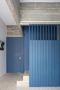 an empty room with blue walls and stairs