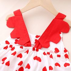 *Title: Baby Girl Heart-shaped Print Bow Decor Ruffle Armhole Dress*Ketword tag: wholesale baby clothes* Fabric: Polyester * Season: Summer * Thickness: Regular * Care Label: On the inside * Package Include: 1 Pieces Sleeveless Heart Print Dress For Valentine's Day, Red Sleeveless Dress With Heart Print, White Sleeveless Dress With Heart Print, Red Heart-shaped Dress For Valentine's Day, White Cotton Dress With Heart Print, Cute Red Valentine's Day Dress, Clothes Fabric, Bow Decor, Types Of Dresses