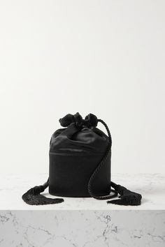 Hunting Season's collections aren't based on trends - the brand says its timeless bags are designed to "move fluidly with you throughout your life." This 'Lola' style is made from glossy black satin with a drawstring top and tasseled straps. There's just enough space inside for your phone, cardholder and makeup compact. Luxury Black Bucket Box Bag, Elegant Evening Bucket Box Bag, Evening Bucket Box Bag With Removable Pouch, Elegant Black Bucket Bag For Evening, Elegant Black Bucket Evening Bag, Black Bucket Box Bag For Evening, Black Bucket Evening Bag For Formal Occasions, Black Formal Bucket Evening Bag, Formal Black Bucket Evening Bag