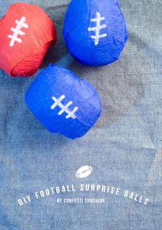 three paper footballs sitting on top of a sheet of blue and red material with the words diy football surprise balls