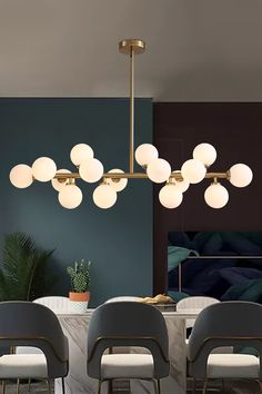 a dining room table with chairs and a chandelier hanging from it's ceiling