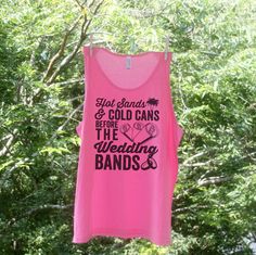 a pink tank top hanging from a clothes line with trees in the backgroud