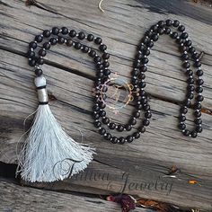 📿Karungali (black ebony wood) is a very powerful tree which our ancestors used. It was used in ancient temples and temple towers (kalasam); was also used in significant homams and other pooja rituals. Ebony Wood Mala is here to remind us to be current and clear-headed so we can make wise and informed decisions. We are being asked to seek new ways to create beauty and harmony that are sustainable for the long-term. This is a time to bring clarity to our intentions as we focus on the future.📿 ✨ Hand-strung Black Jewelry For Festivals, Spiritual Black Beaded Necklaces With Round Beads, Black Spiritual Beaded Necklace With Round Beads, Black Spiritual Beaded Necklaces, Black Wooden Beads For Meditation, Traditional Hand-strung Black Mala, Traditional Black Hand-strung Mala, Traditional Black Mala With 108 Beads, Black Spiritual Beads For Meditation