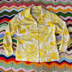 1970s, PYKETTES Brand, Nylon/Rayon Blend Shirt. Revere Collar, Notched Hem. A Little Bit Of Volume In Sleeves. Faux Pearl Buttons Down Front And At Cuffs. Darts At Chest.   Good Condition- All Original Buttons In Tact. No Major Flaws. 2 Small Marks On Right Sleeve Near Cuff, See Up Close Photo. No Size Tag. Measures: 42" CHEST  27" LONG 32" SLEEVE 1970s Long Sleeve Tops With Retro Print, 1970s Style Long Sleeve Tops With Retro Print, 1970s Retro Print Long Sleeve Tops, Retro Yellow Button-up Blouse, Vintage Yellow Top With Retro Print, Retro Yellow Collared Top, Yellow Collared Retro Top, Retro Yellow Tops With Retro Print, Yellow Retro Collared Tops