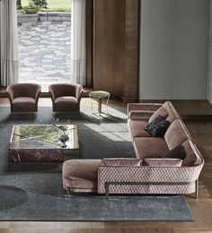 a living room with couches, chairs and tables in front of a large window