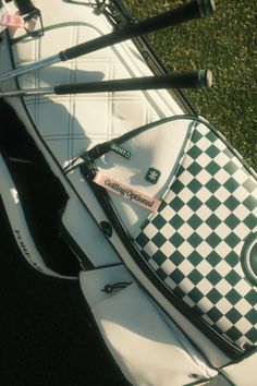 a white and black bag sitting on top of a surfboard next to two paddles